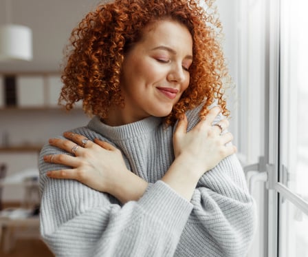 Women hugging herself and showing love.